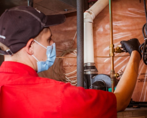 AtlasCare technician inspecting hot water valves